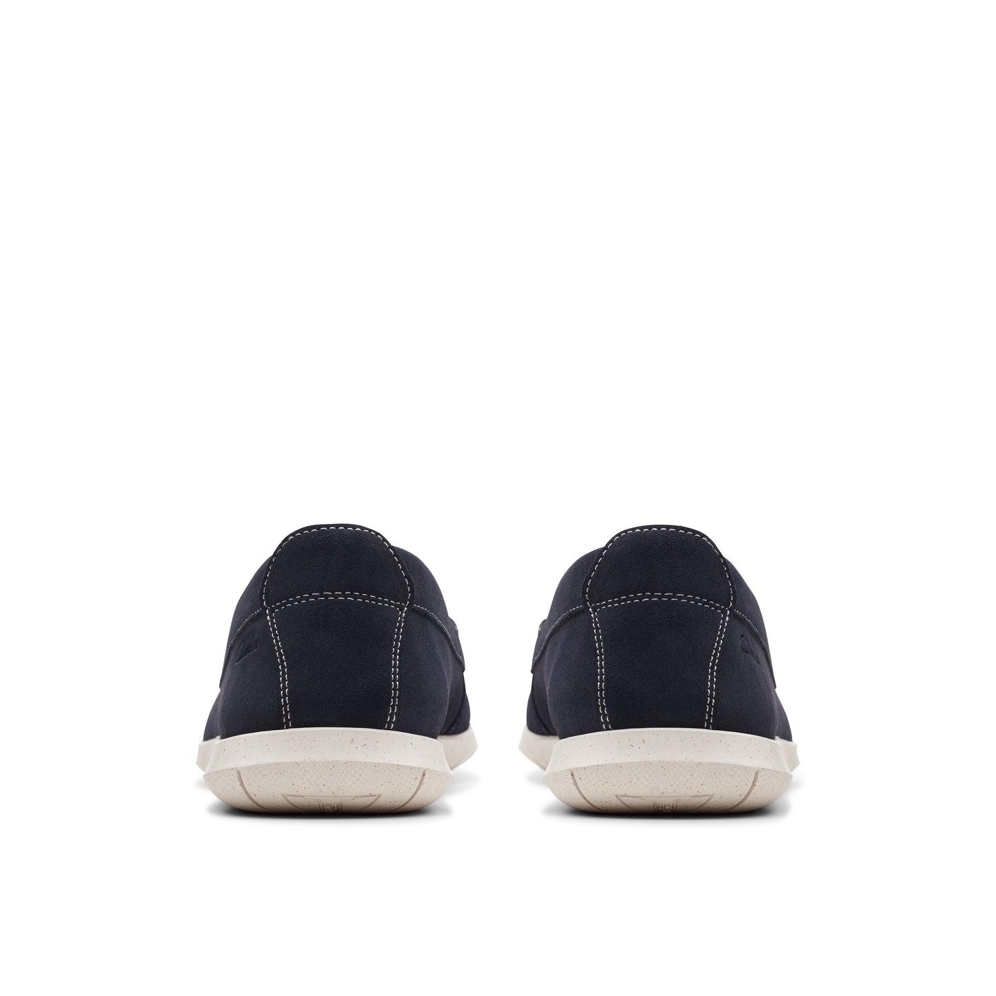 Rear view of two navy blue loafers with white stitching and light tan soles.