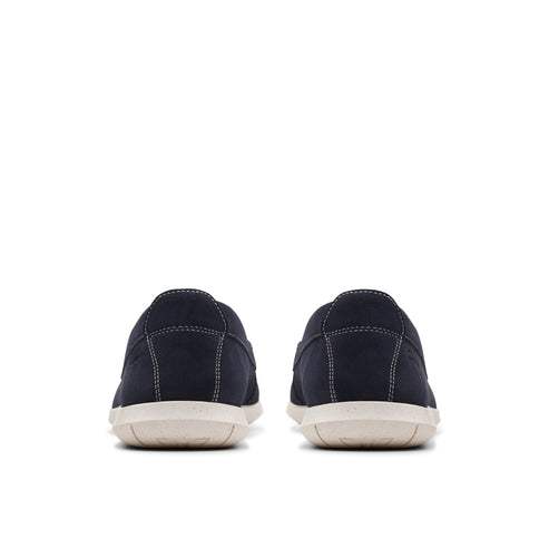 Rear view of two navy blue loafers with white stitching and light tan soles.