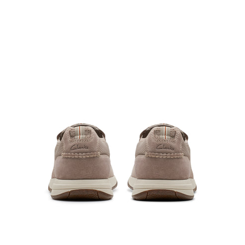 Pair of low-profile, slip-on taupe shoes with visible brand name at the heel.