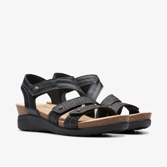 Two black leather sandals with adjustable straps and a low wedge heel.