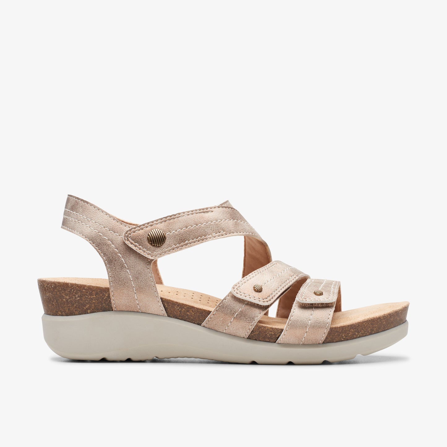 Gold strappy sandal with hook and loop closures and a low wedge heel.