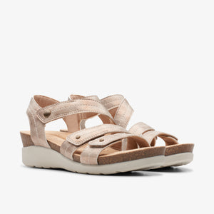 Pair of women's flat, champagne-colored sandals with straps and velcro closures.