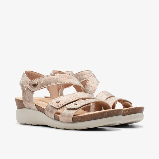 Pair of women's flat, champagne-colored sandals with straps and velcro closures.