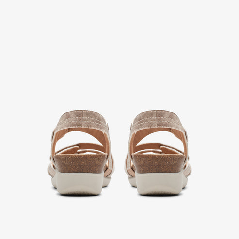 Rear view of two beige sandals with a cork wedge heel and adjustable heel strap.