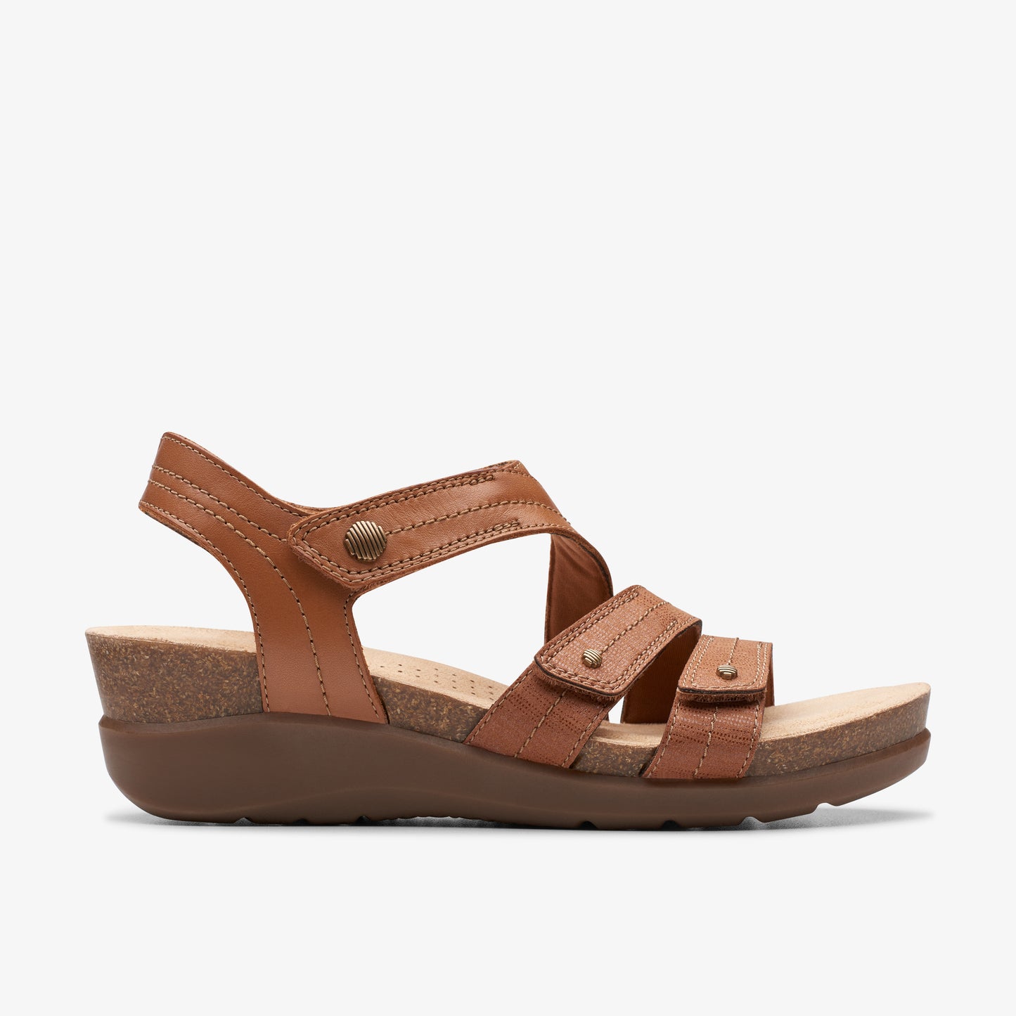 Brown leather sandal with adjustable straps and cork wedge heel.