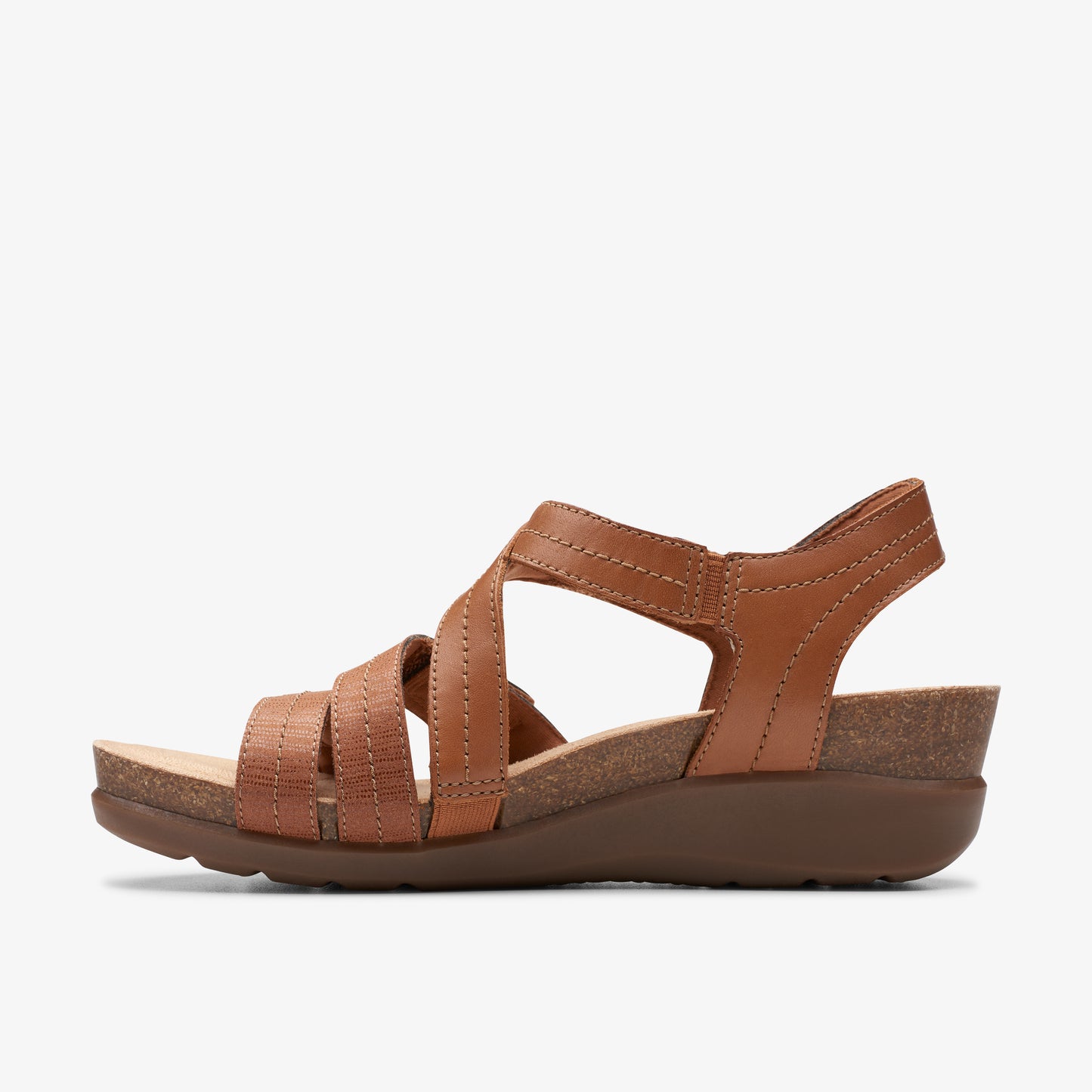 A tan leather sandal with multiple straps and a slight wedge heel.