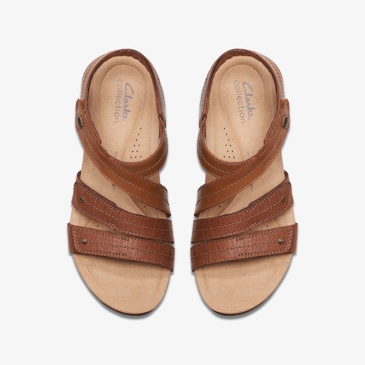 Two brown leather sandals with straps and metal accents.