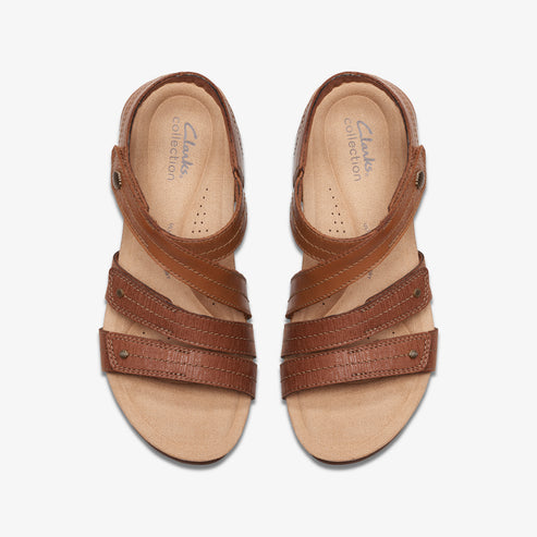 Two brown leather sandals with straps and metal accents.