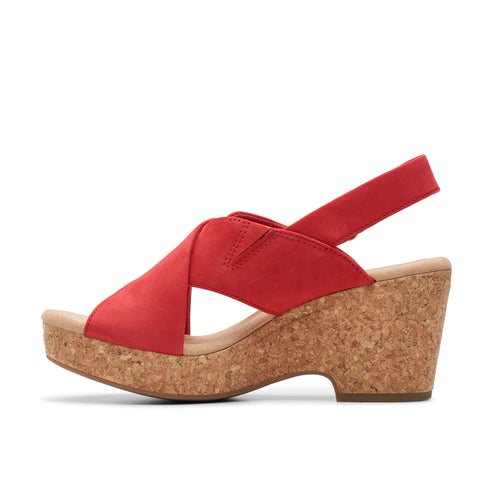 Red sandal with cork wedge heel and criss-cross straps.