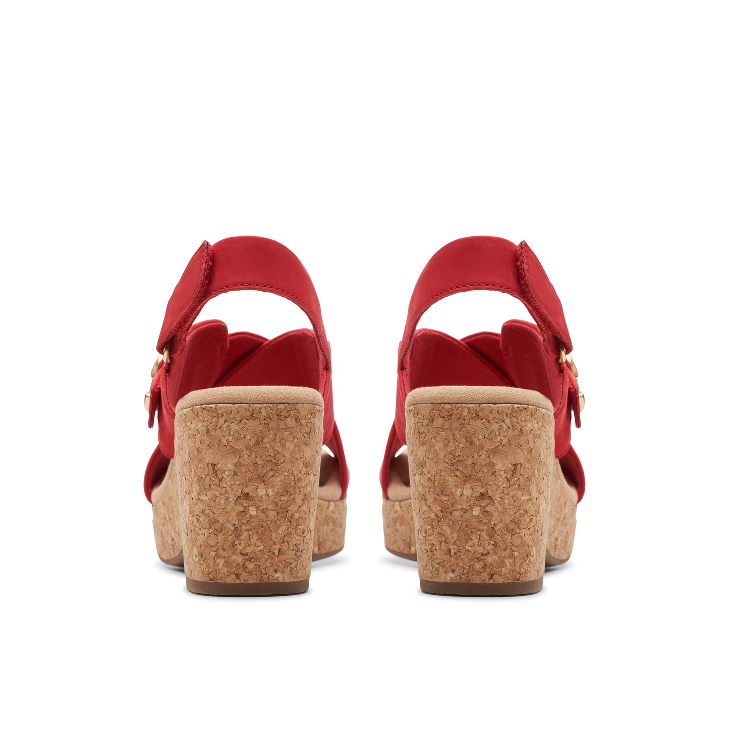 Red wedge sandals with cork heels and buckle straps, rear view.