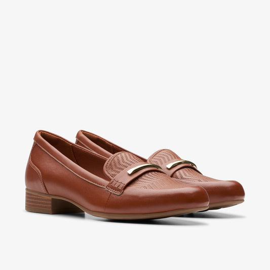 Pair of brown leather loafers with a gold-tone accent.