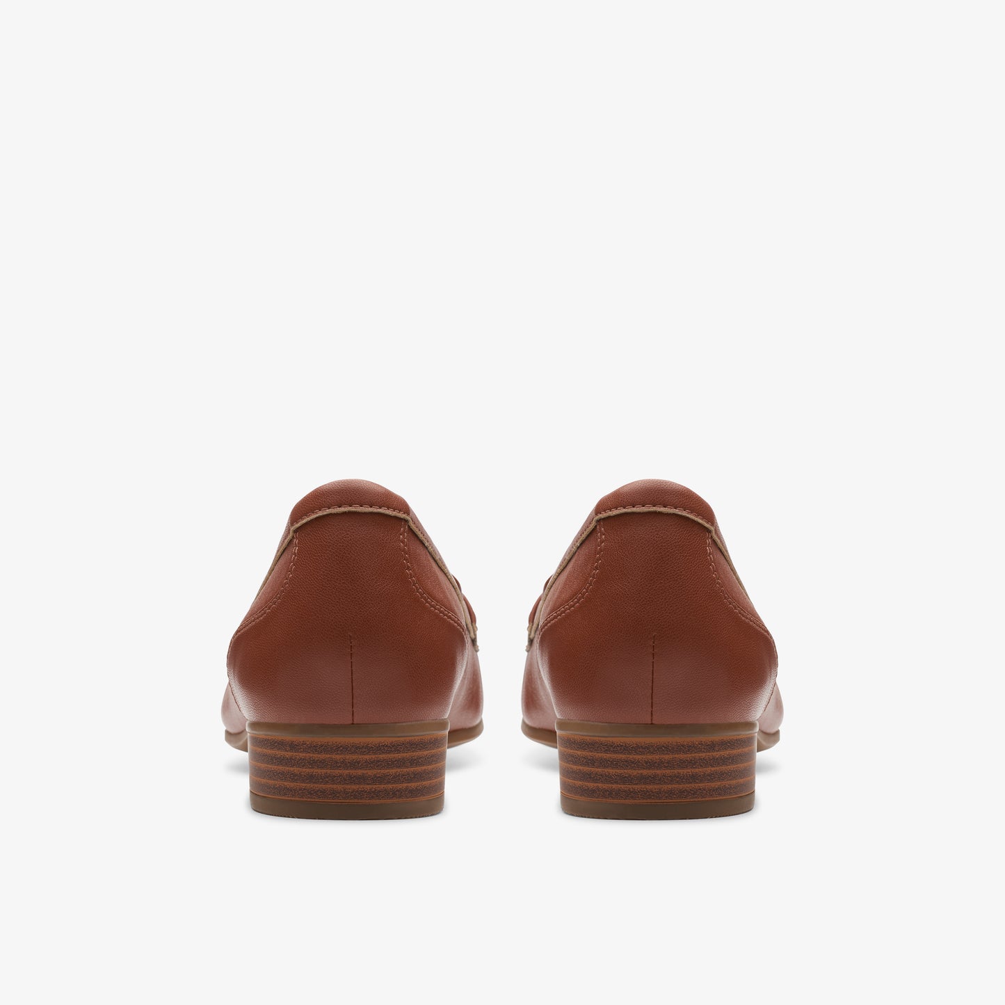 Rear view of a pair of brown leather loafers with a low heel.