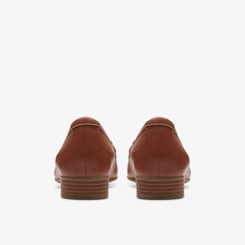 Rear view of a pair of brown leather loafers with a low heel.