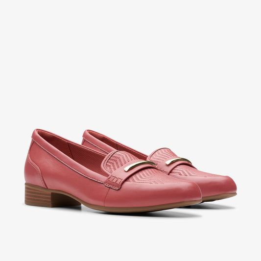 Pair of rose-colored leather loafers with low block heels and gold-colored metal decoration