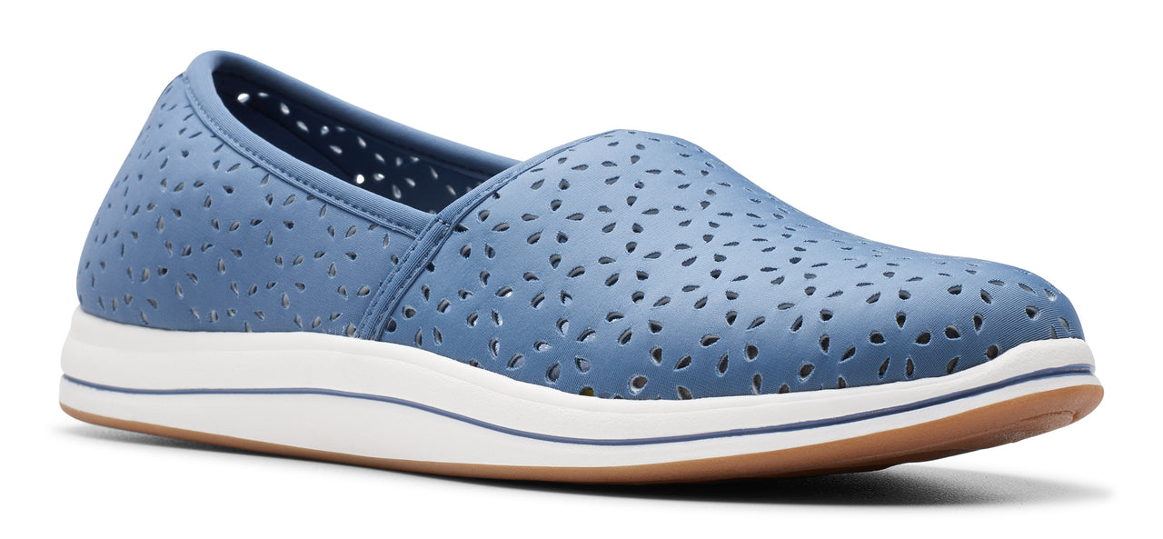 A blue slip-on shoe with perforated details and a white and brown sole.