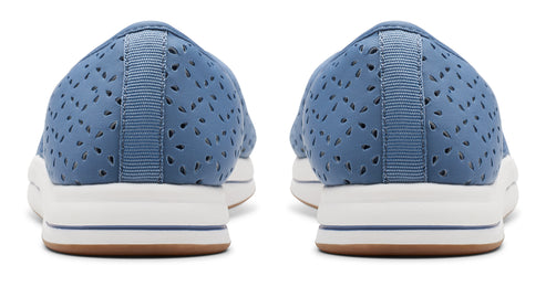 Rear view of a pair of light blue perforated slip-on shoes with white platform soles and brown outsoles.