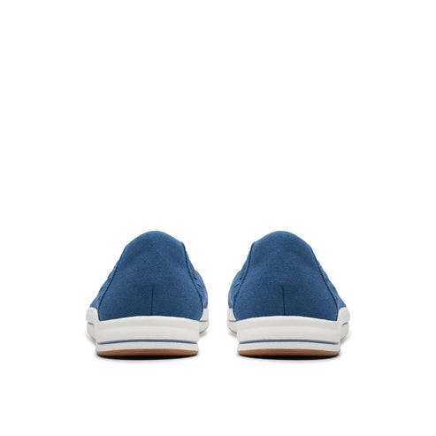 View of the back of a pair of blue slip-on shoes with white soles.