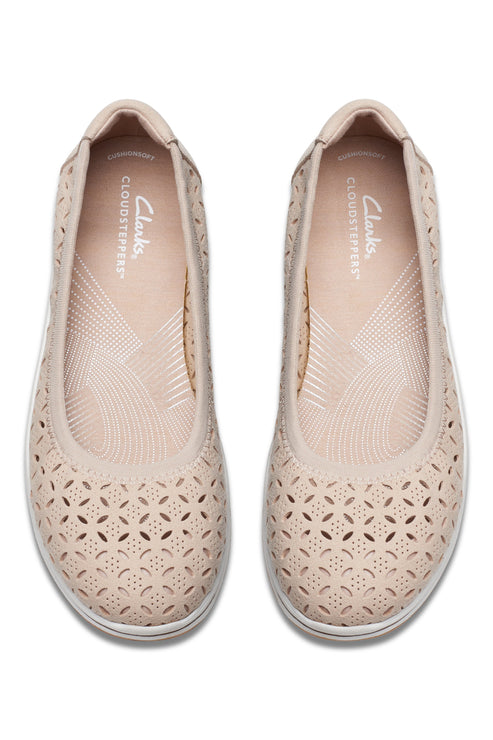 Pair of beige flats with patterned perforations.