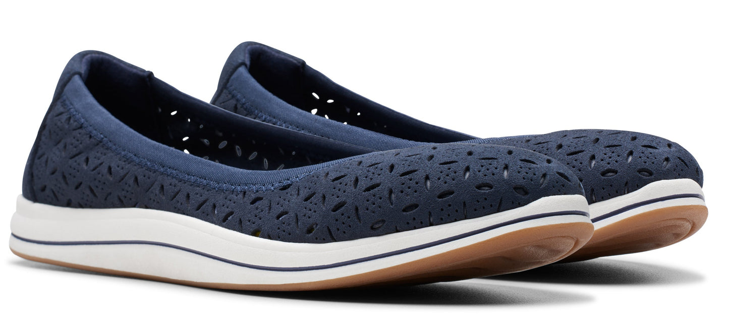 A pair of navy blue ballet flats with decorative perforations and a white sole.