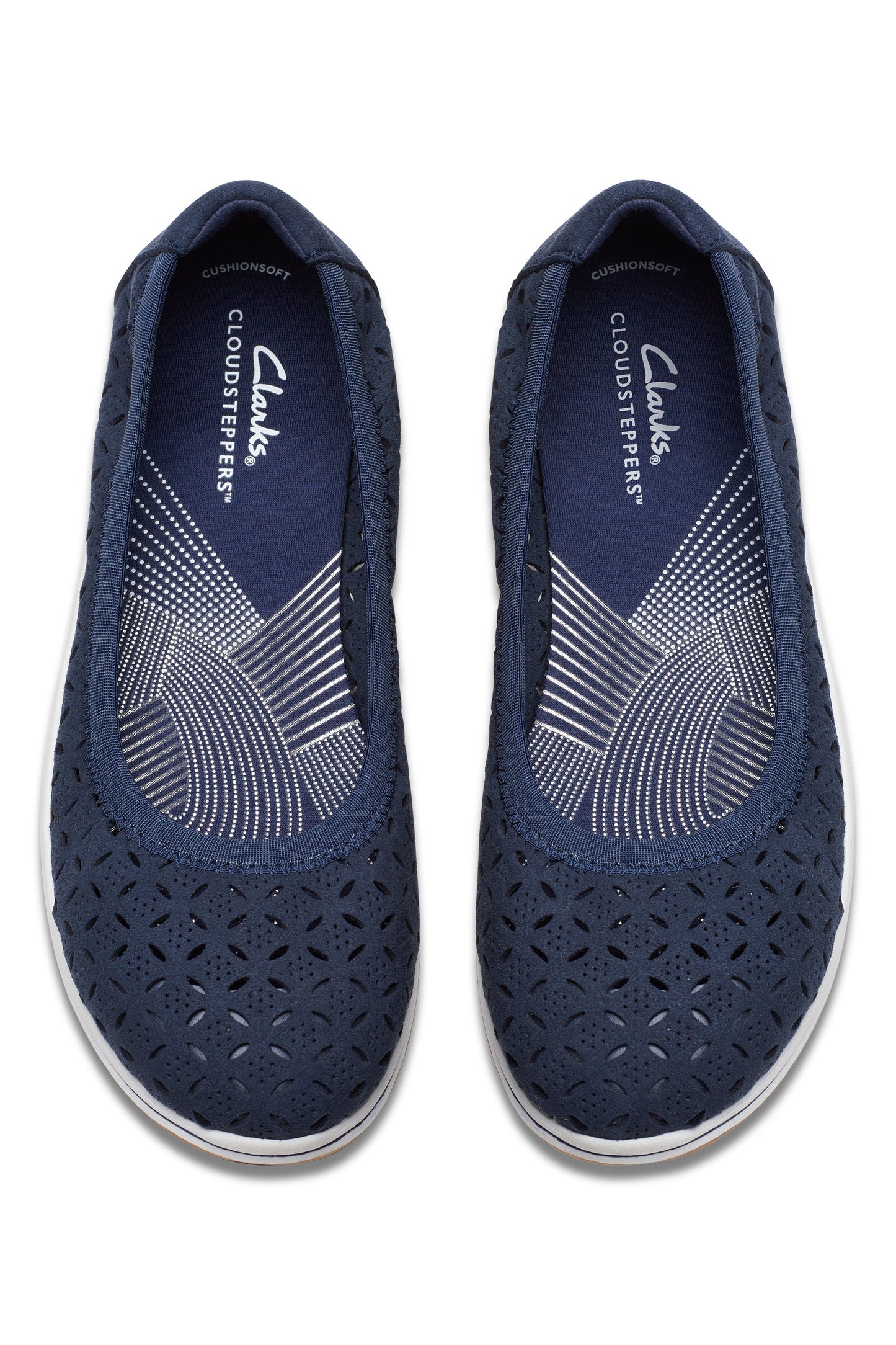 Overhead view of a pair of navy blue, slip-on, ballet flat style shoes with decorative laser cutouts.