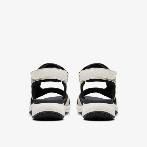Pair of sandals with black soles and white straps.
