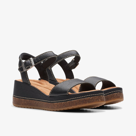 A pair of black platform sandals with buckle straps and a brown sole.
