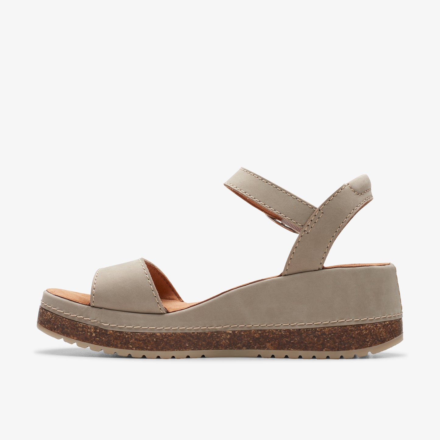 Side view of a beige sandal with an ankle strap and a platform cork sole.