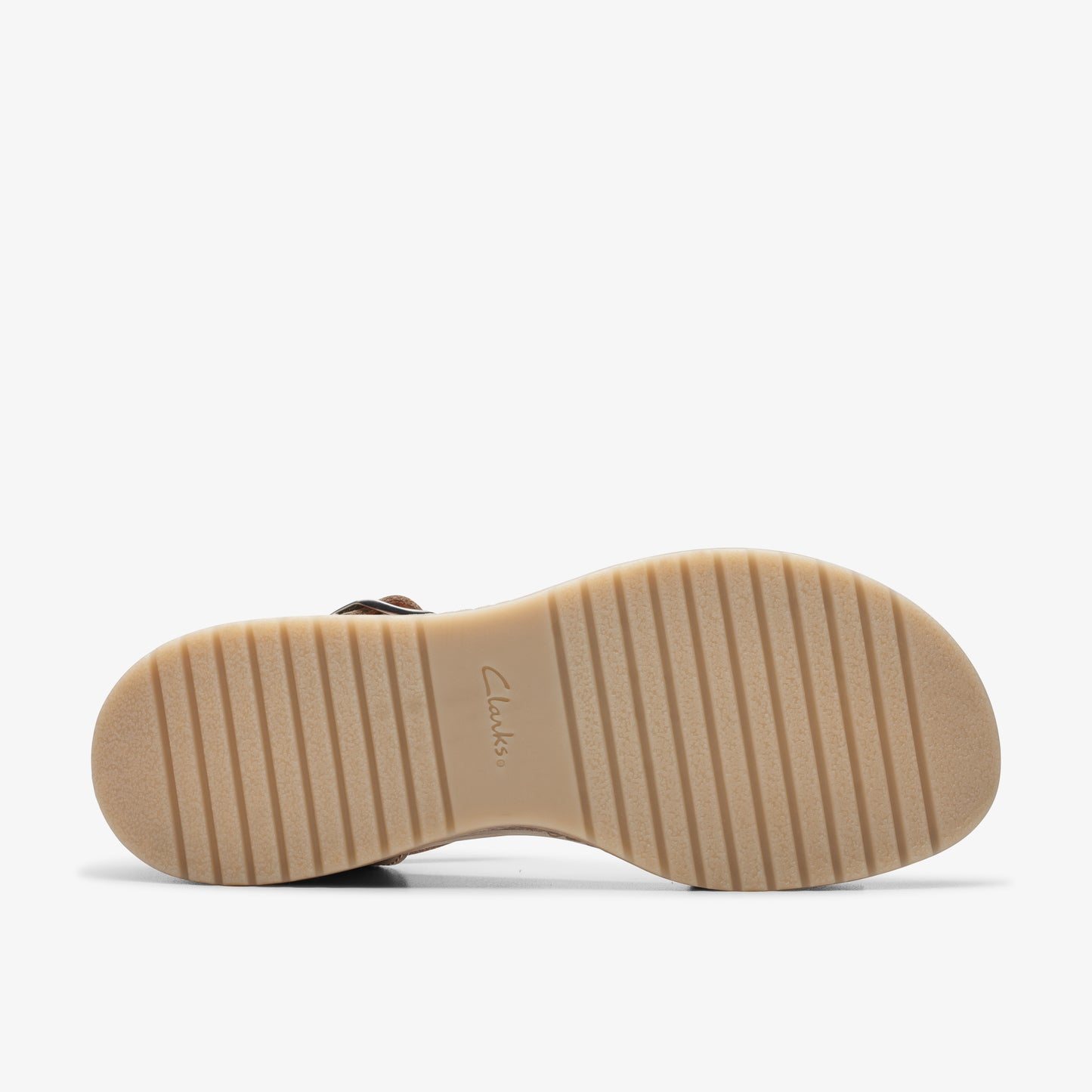 Close up of the tan-colored ridged outsole of a sandal.