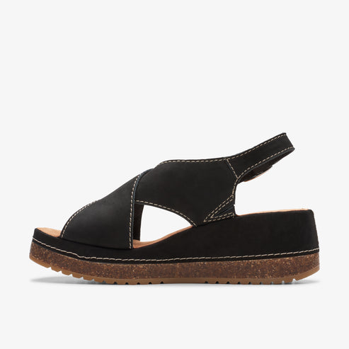Black platform sandal with criss-cross straps and cork sole.