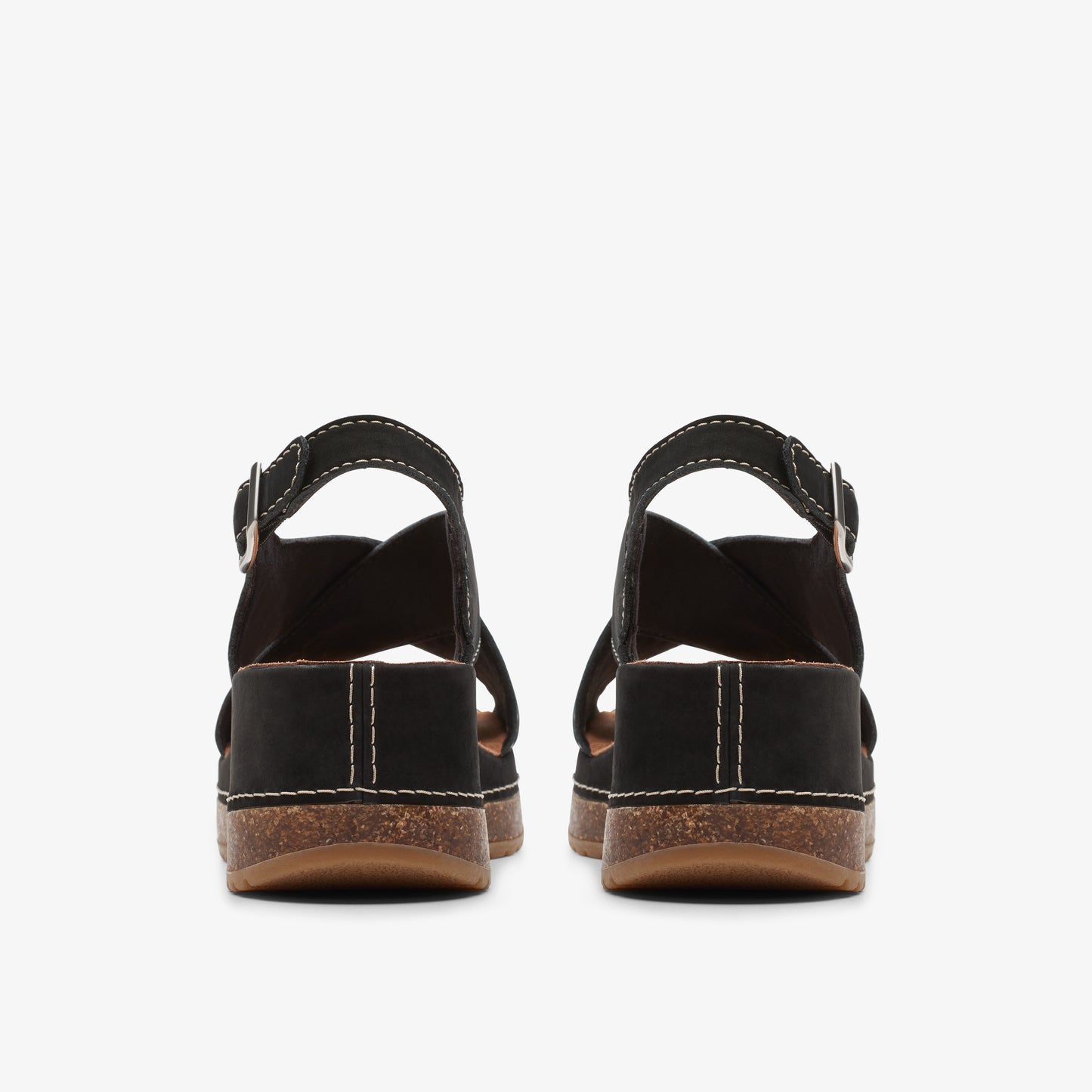 Back view of a pair of black sandals with adjustable ankle straps and white stitching along the midsoles.