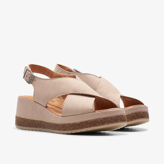 Beige, leather, wedge sandals with criss-cross straps and buckle.