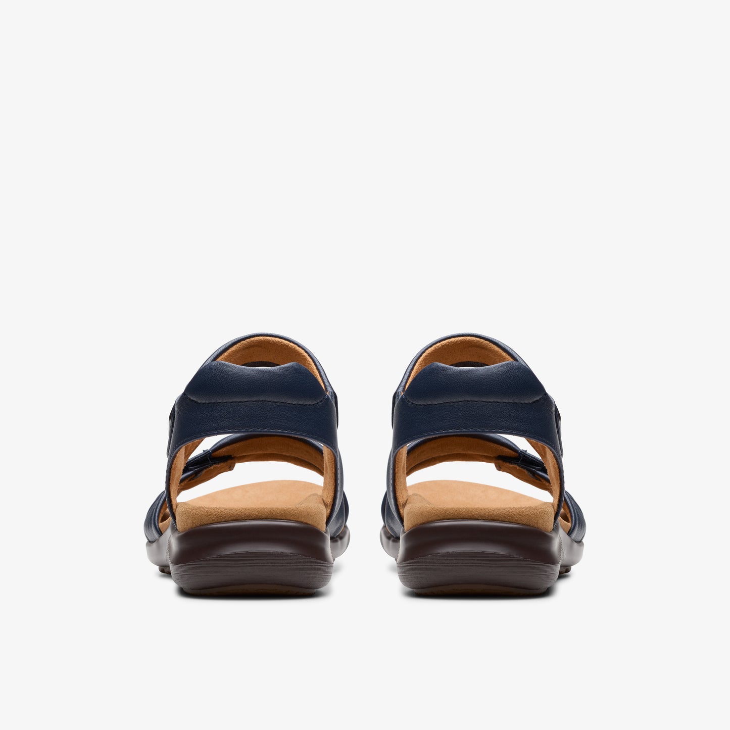 Pair of navy-blue sandals with thick brown soles, rear view.