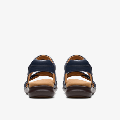 Pair of navy-blue sandals with thick brown soles, rear view.