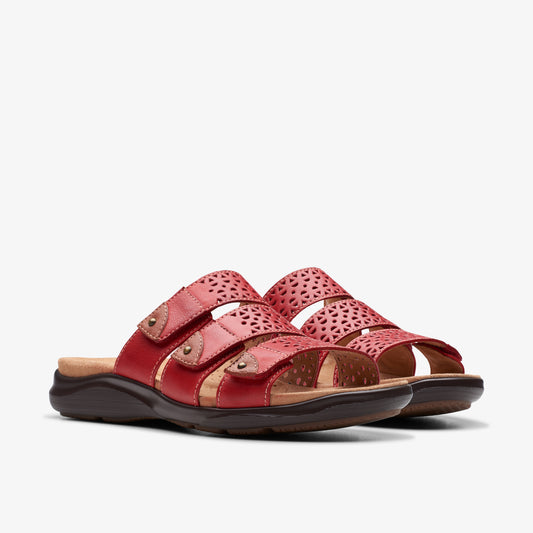 Pair of red leather sandals with perforated straps and adjustable velcro closures.
