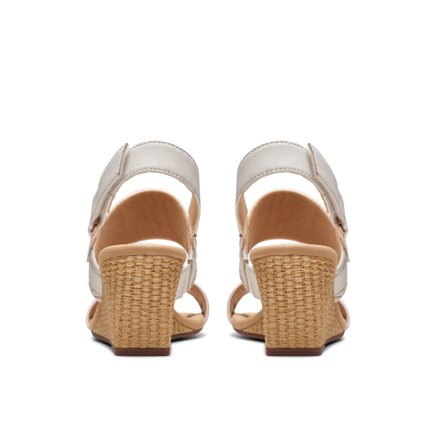 Pair of wedge sandals with velcro straps and woven heels, viewed from the back.
