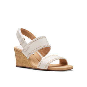 White wedge sandal with adjustable heel strap and braided trim.