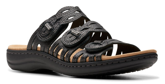 Black sandal with decorative round straps, buckles, and tan insole.