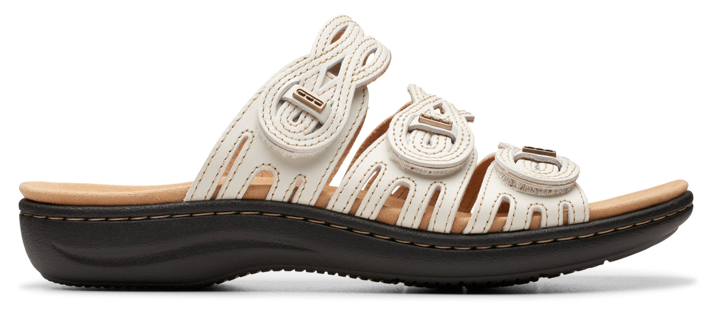 White sandal with three adjustable hook and loop straps.