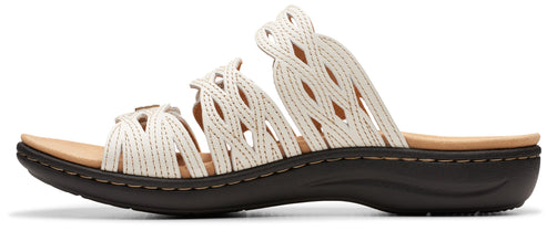 A sandal with a white open-weave upper and a dark sole.