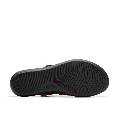 Close-up of the sole of a sandal with wavy treads and the text "Clarks".