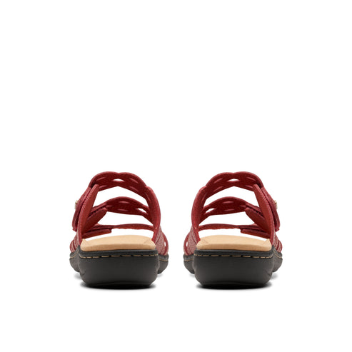 Rear view of two red sandals with adjustable straps, showing stacked midsoles and treaded soles.