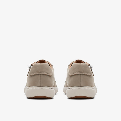 Pair of tan sneakers, back view.