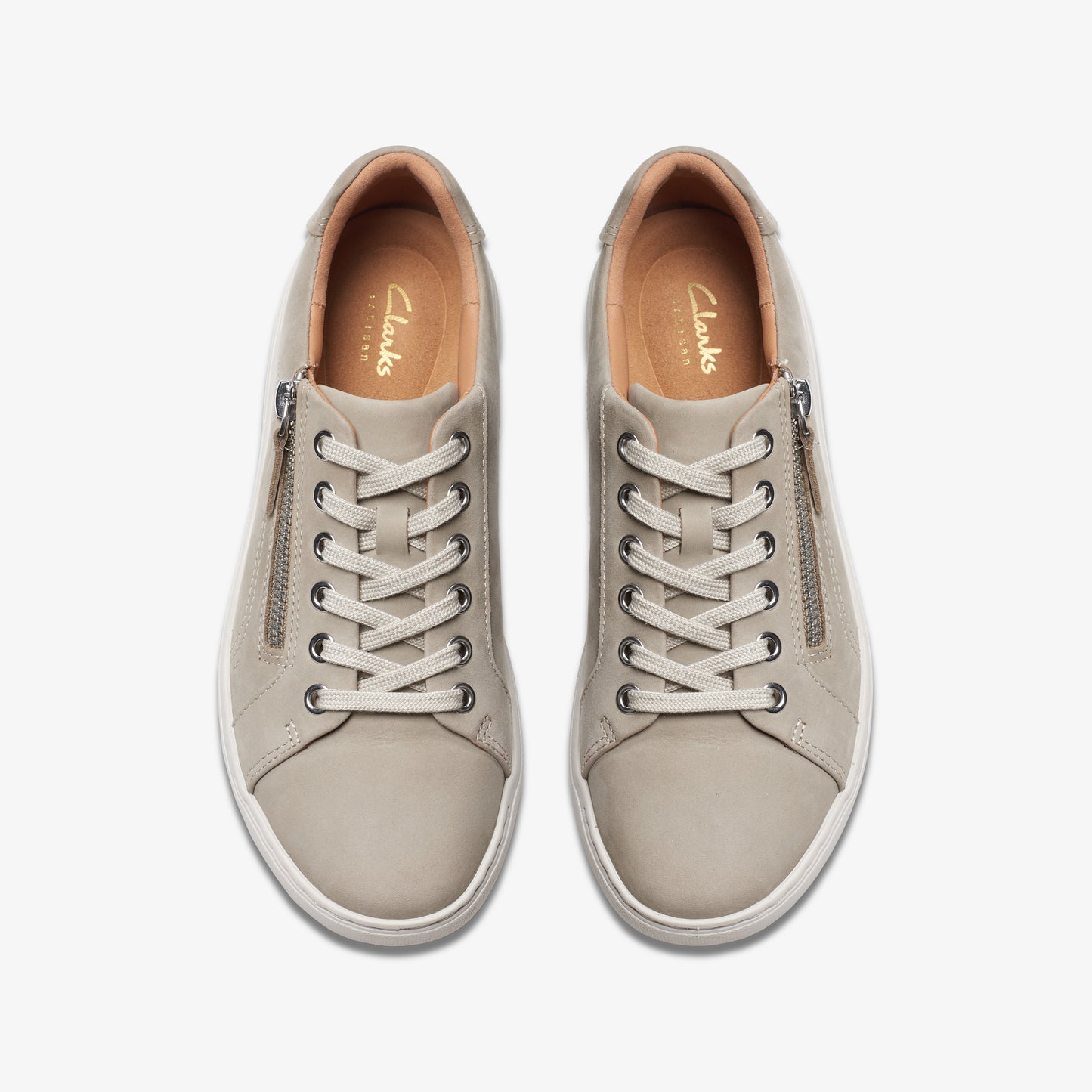 Overhead shot of two identical sneakers: gray, lace-up, rounded toe, side zipper, "Clarks" imprinted on the tan insole.