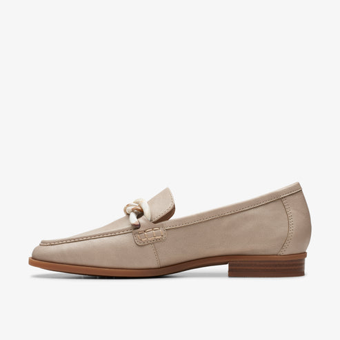 Beige leather loafer with knot detail and a low heel.
