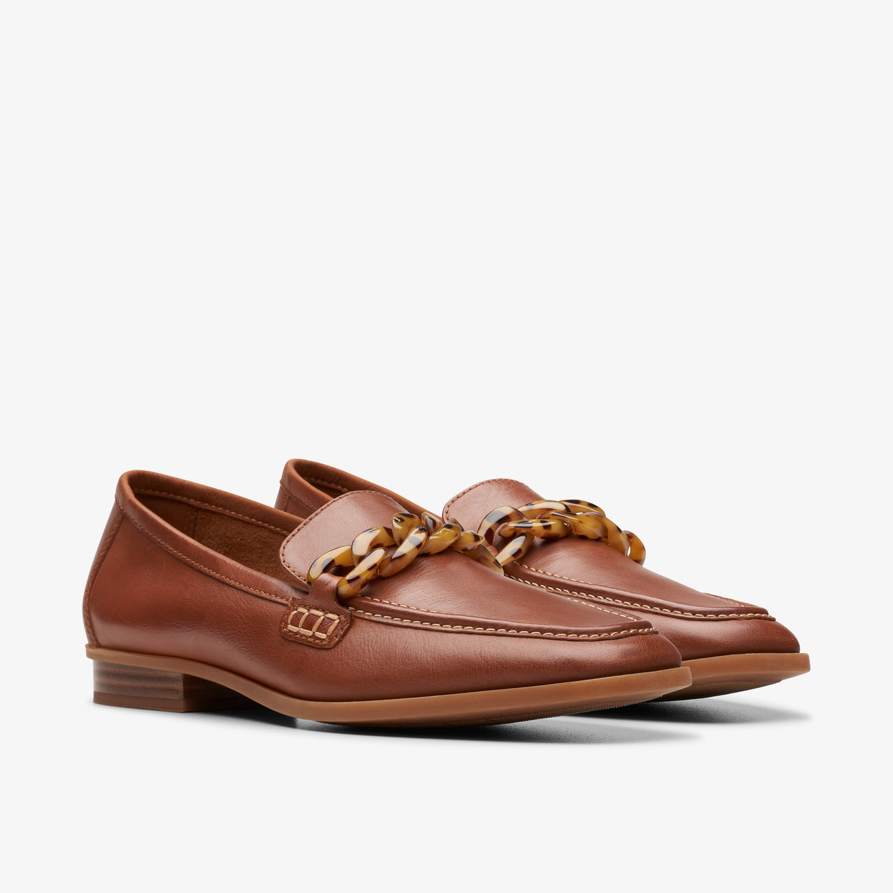 Pair of brown leather loafers with a tortoiseshell-style chain accent.