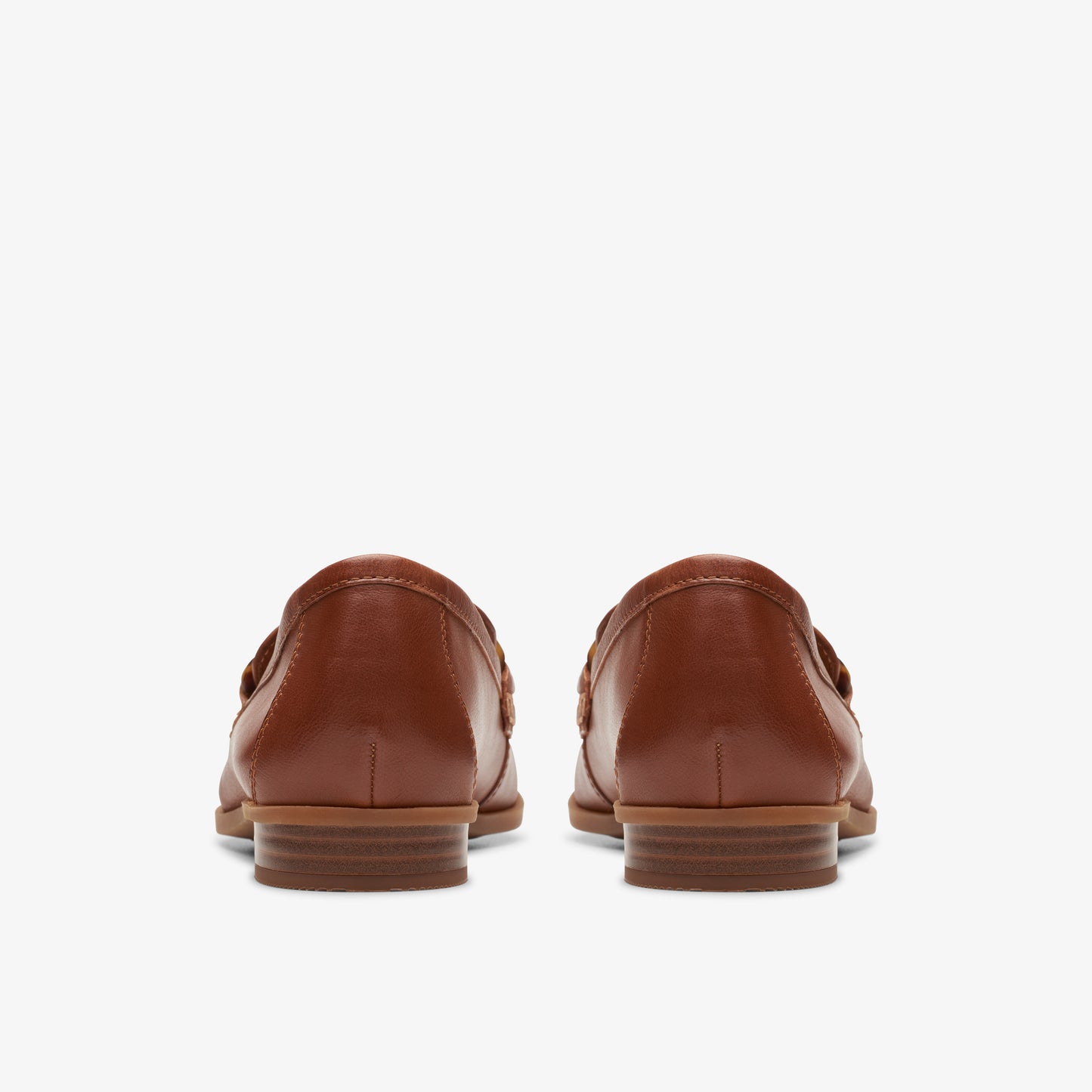Pair of brown leather loafers, back view.