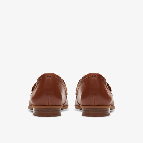 Pair of brown leather loafers, back view.