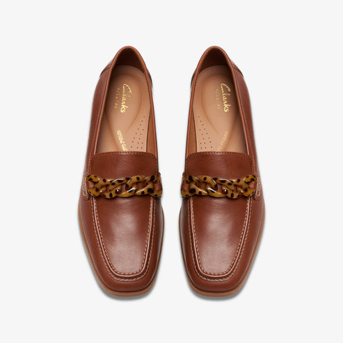 Pair of brown leather loafers with decorative tortoiseshell chains across the vamp.