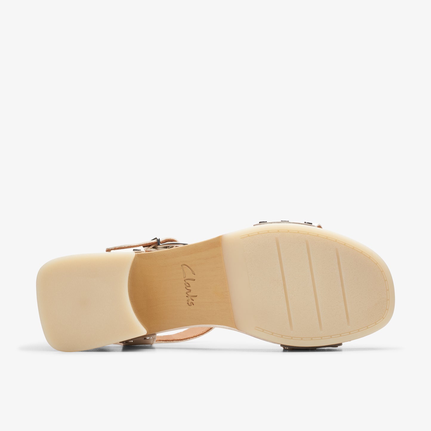 Bottom of a light-colored women's sandal showing its chunky heel and the brand name "Clarks" embossed in the middle.