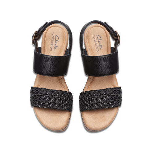 Overhead view of two black sandals with woven straps and adjustable buckles.